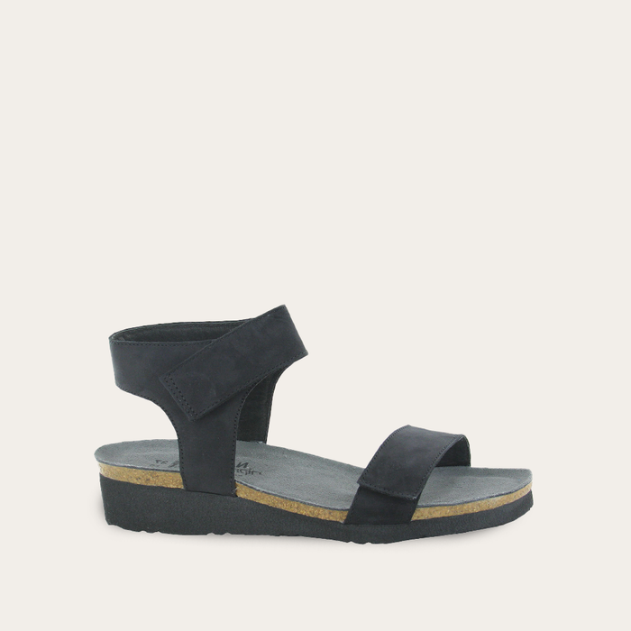 A black comfort sandal with two adjustable straps and a low cork wedge sole.