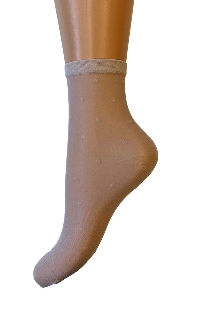 Champagne sock with white polka dots against a white background