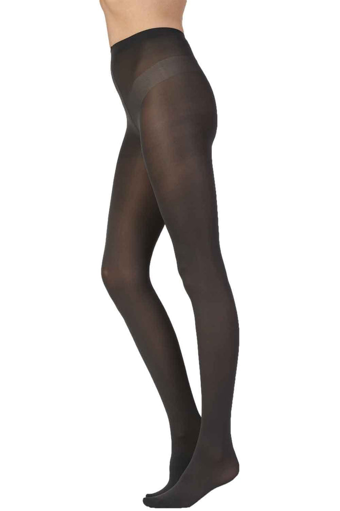 Black tights worn by a person on a white background