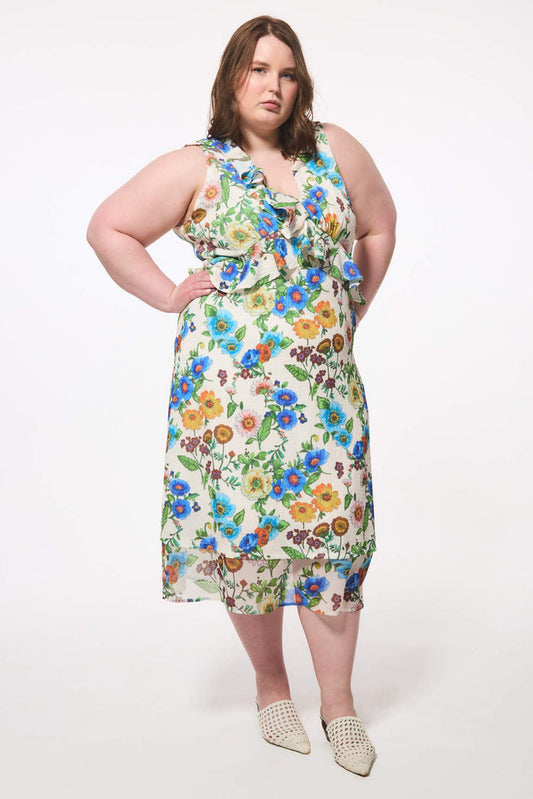 Plus size woman wearing a floral wedding guest dress that was made in Canada on a white background