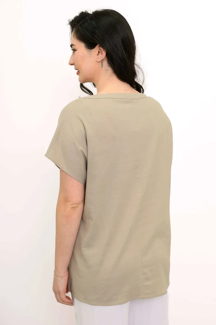 Woman wearing a beige t-shirt against a white background