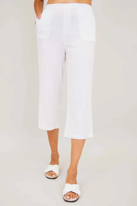 Person wearing white pants on a plain background