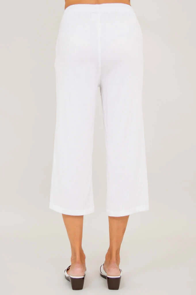 White pants worn by a person on a plain white background