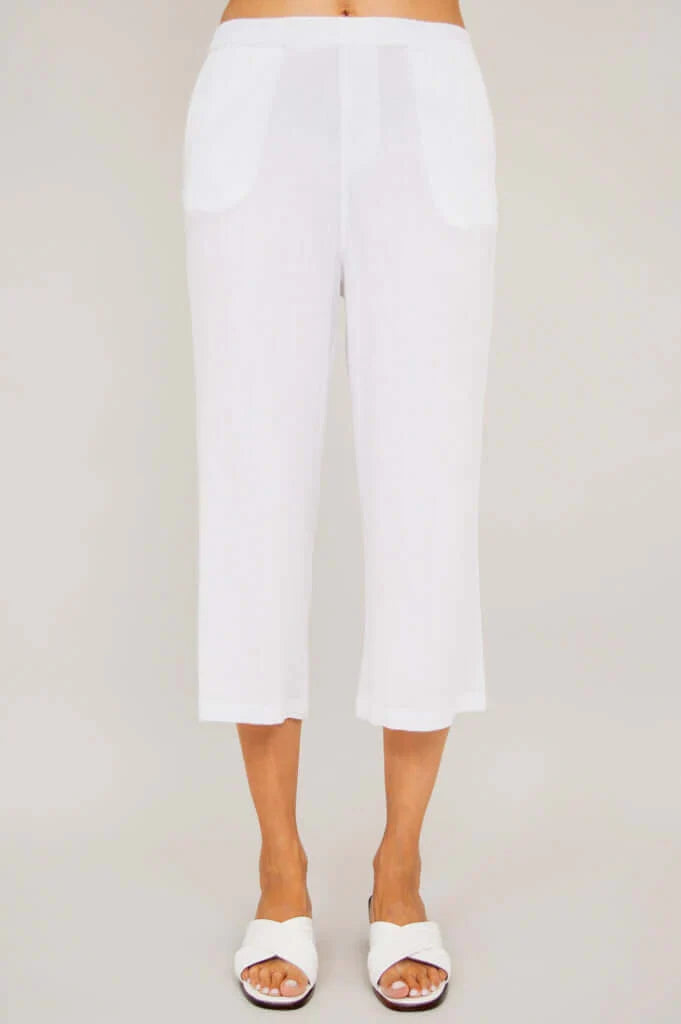 White pants worn by a person on a plain background