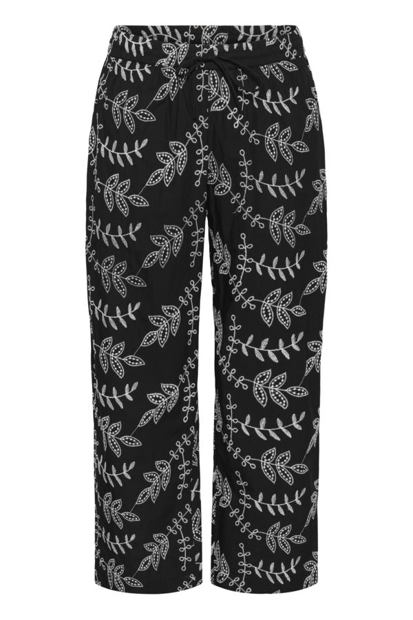 Black pants with white floral pattern on a white background