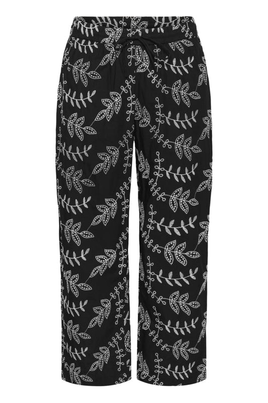 Black pants with white floral pattern on a white background