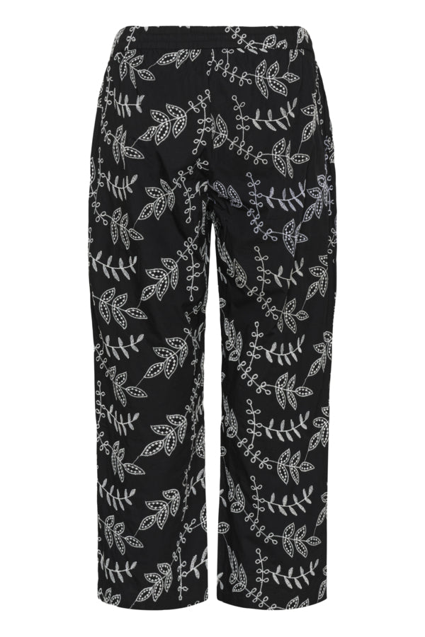Black pants with white floral pattern on a white background