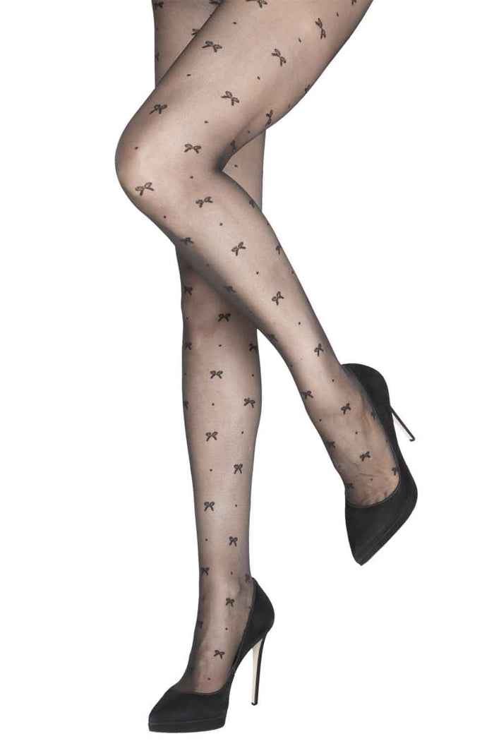 Sheer tights with bow pattern worn with black high heels on a white background