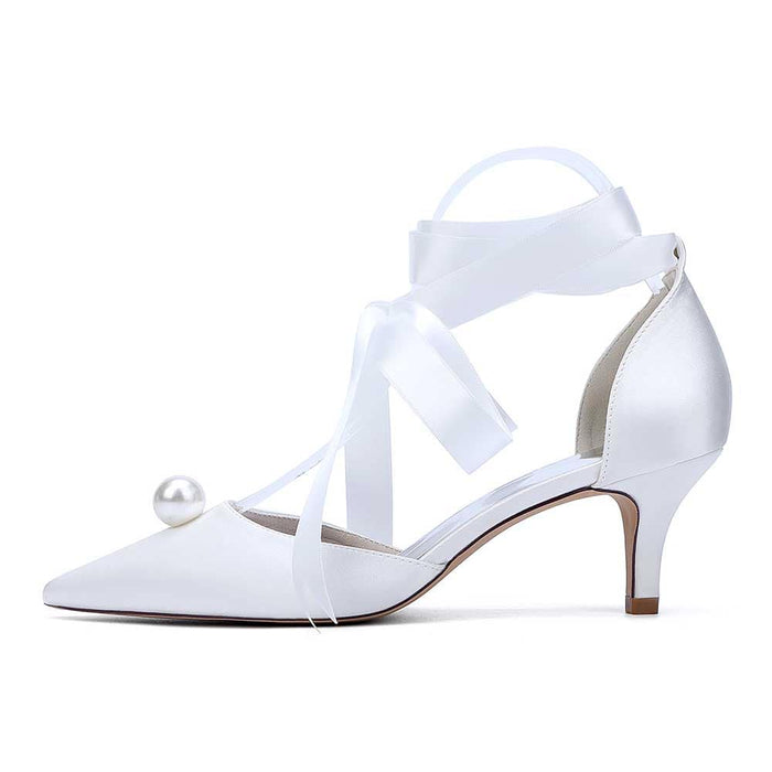 White bridal ankle strap heels with pearls and elegant ribbon detail for a stylish wedding look