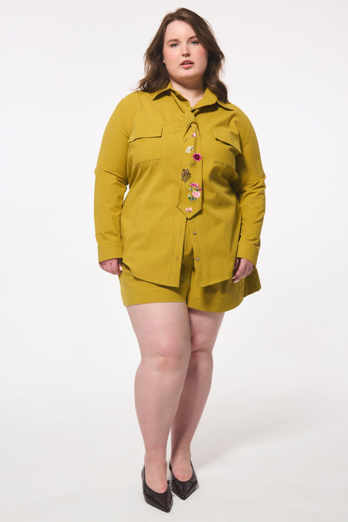 Woman wearing a blouse and shorts set on a white background