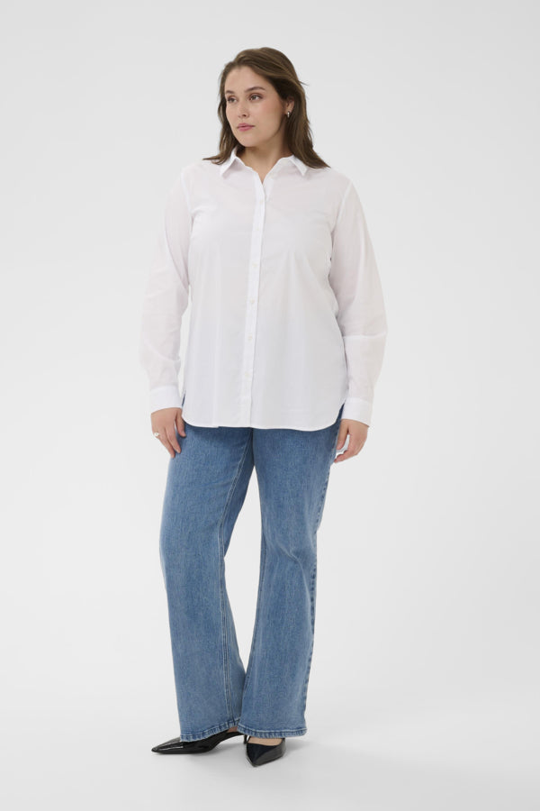 Woman wearing a white shirt and blue jeans on a white background