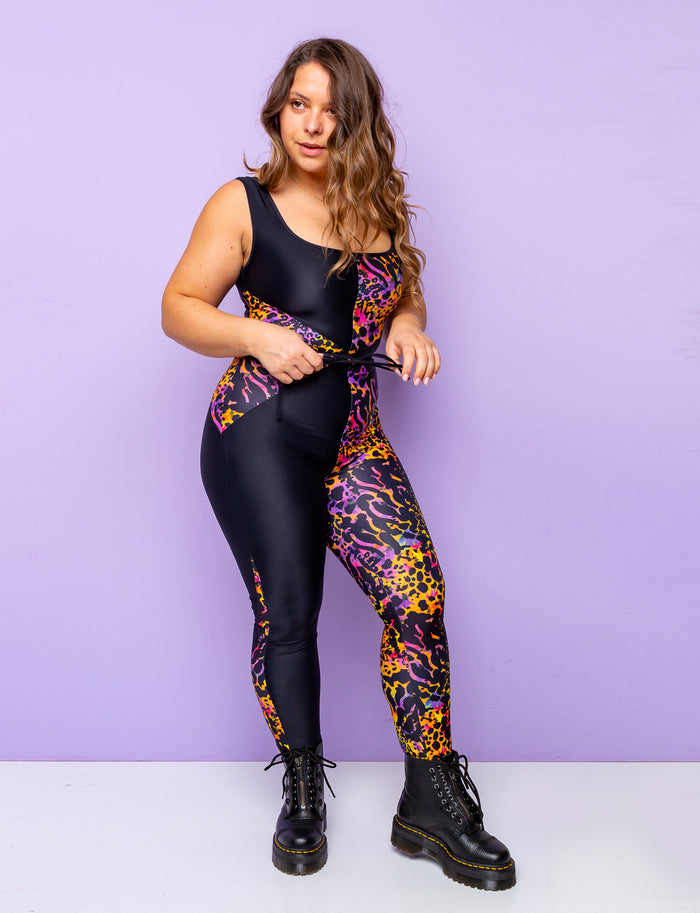 Woman modelling a purple leopard print catsuit with contrasting black panels.