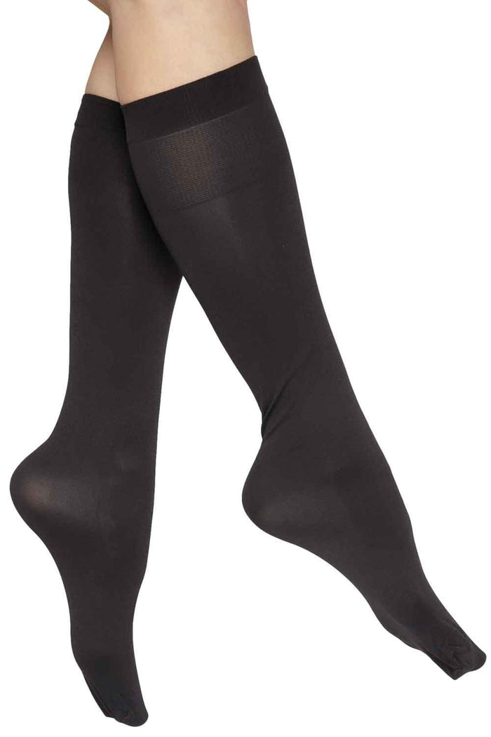 Black comfort top knee highs worn by a person on a white background