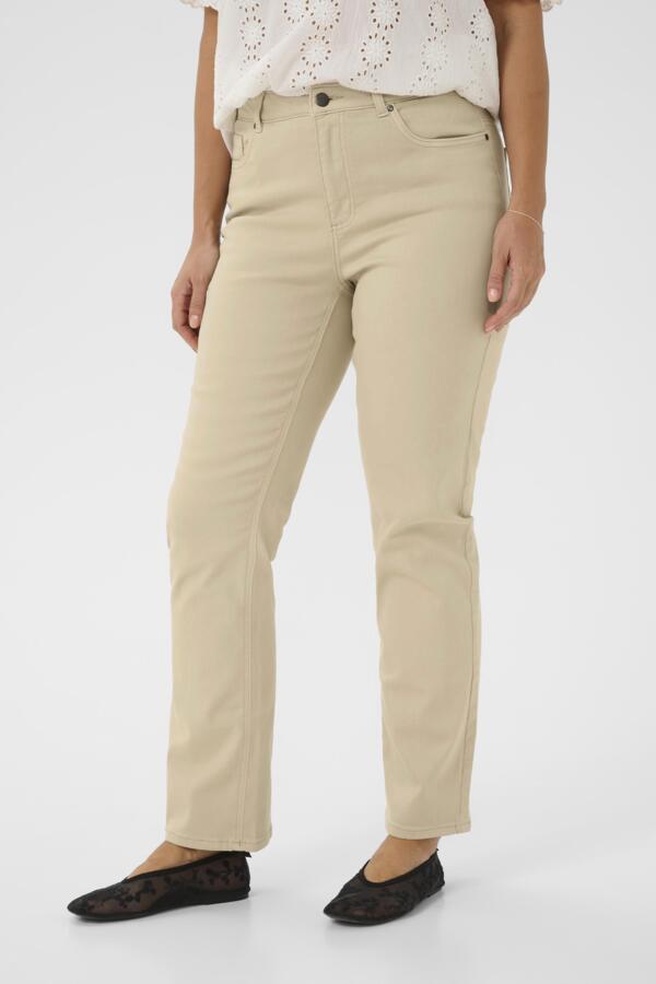 Beige pants worn by a person on a white background
