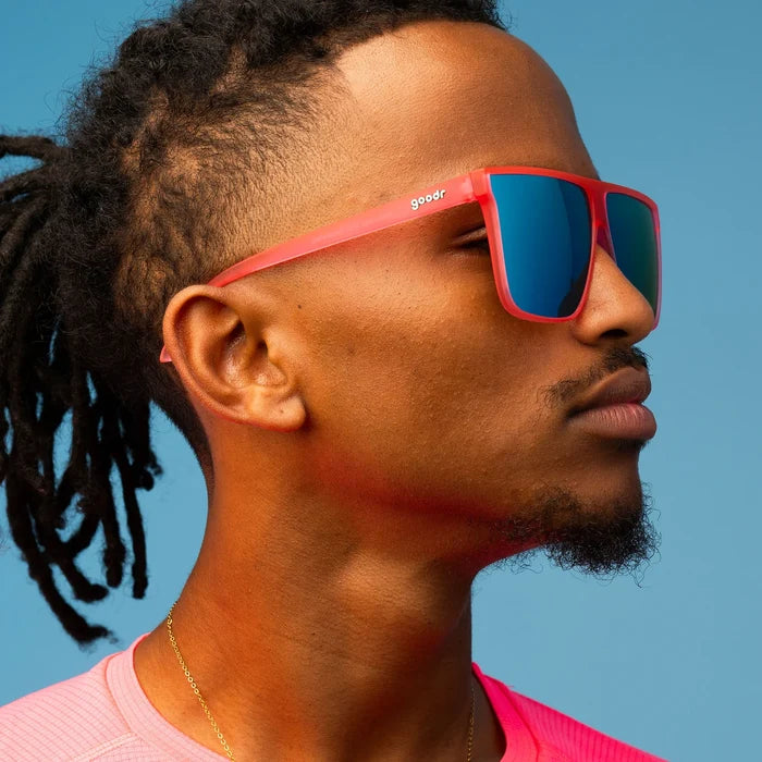 Style and fit showcase of hot pink sunglasses with mirrored reflective lenses in teal. Flat-top frames with a wider fit. No slip, no bounce, all polarised.