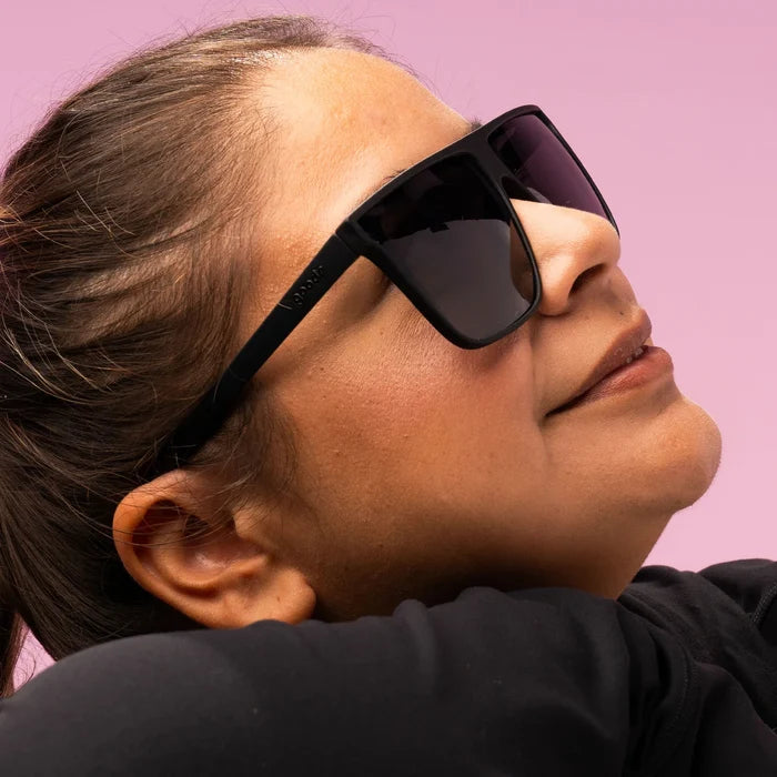 Style and fit showcase of black wide-fit, oversized sunglasses with non-reflective lenses. No slip, no bounce, all polarised.