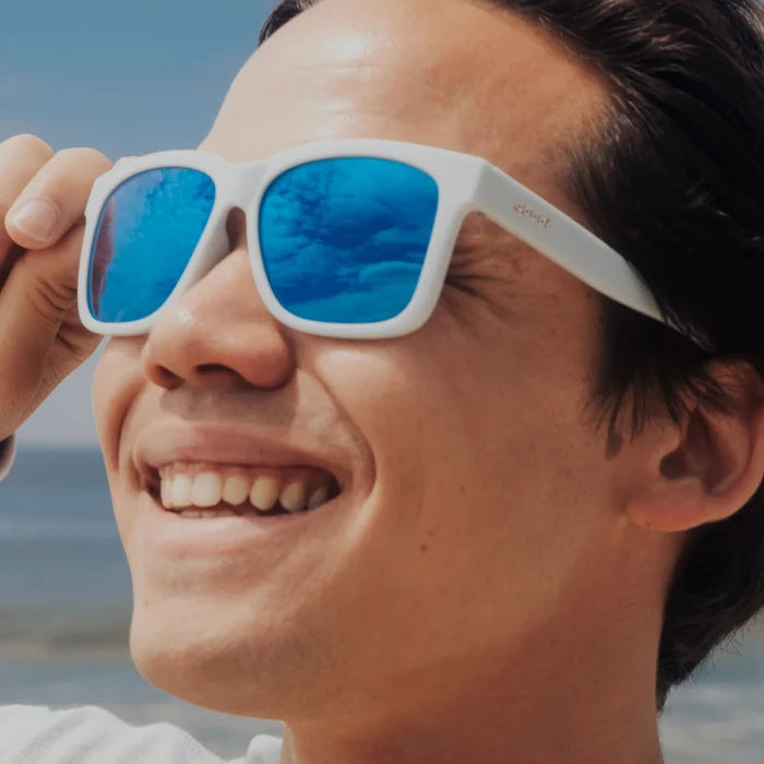 Fit and style showcase of light blue sunglasses with mirrored reflective lenses. Water repellent and capable of floating.