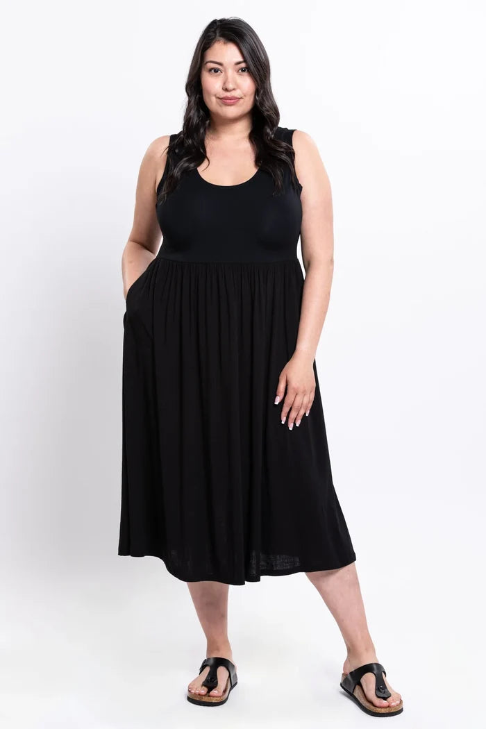 Woman wearing a black sleeveless dress on a white background