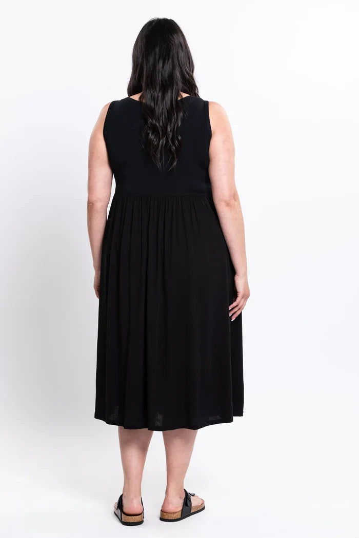 Woman wearing a black sleeveless dress on a white background