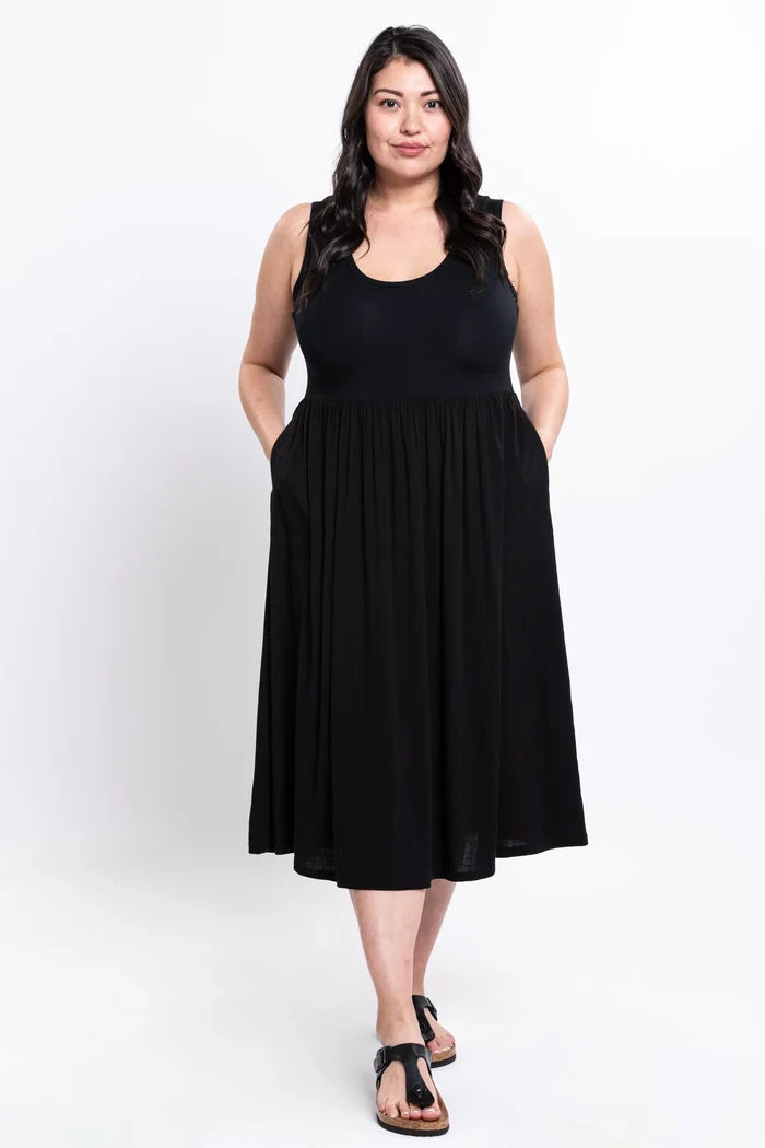 Woman wearing a black sleeveless dress on a white background