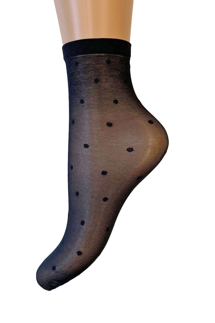 Black polka dot sock against a white background