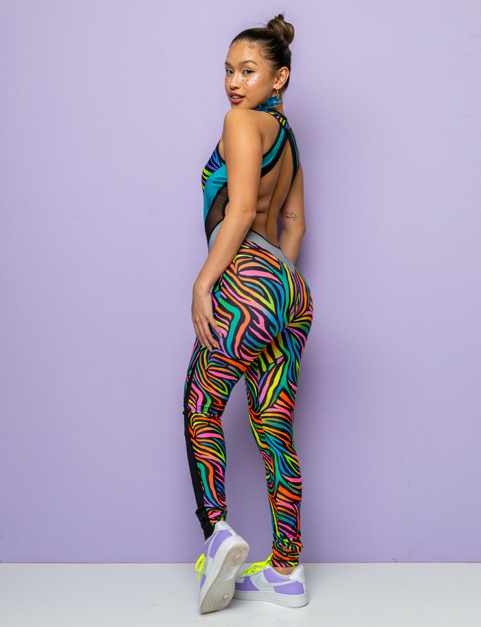 Back view of Woman modelling a backless multi coloured zebra print catsuit.