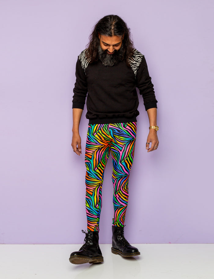 Man modelling rainbow zebra mens leggings and black zebra print sweatshirt.