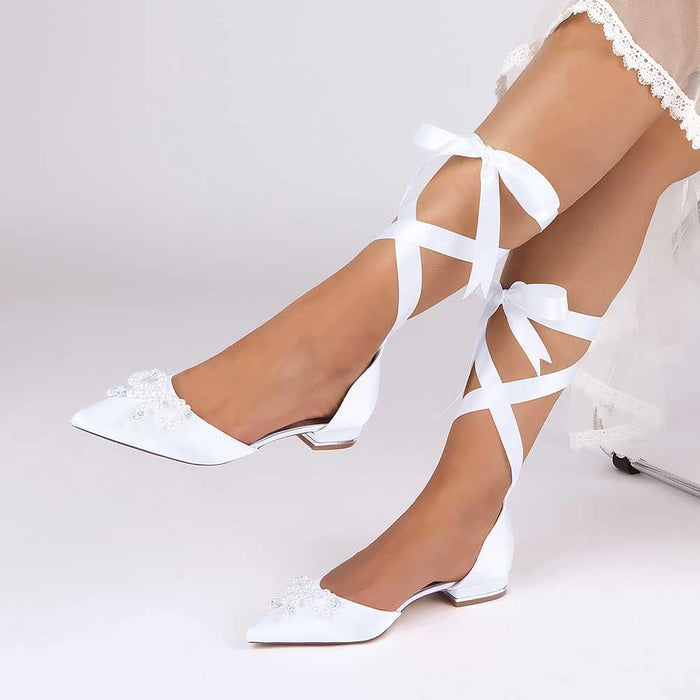 Bridal ankle strap flat shoes in white with lace and floral embellishments