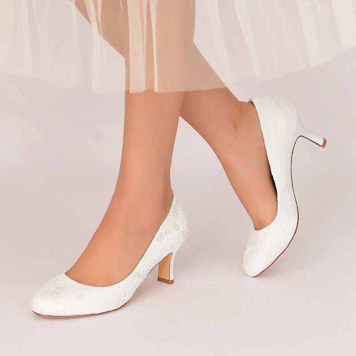 Elegant white closed toe bridal pumps for women with a stylish design, perfect for weddings