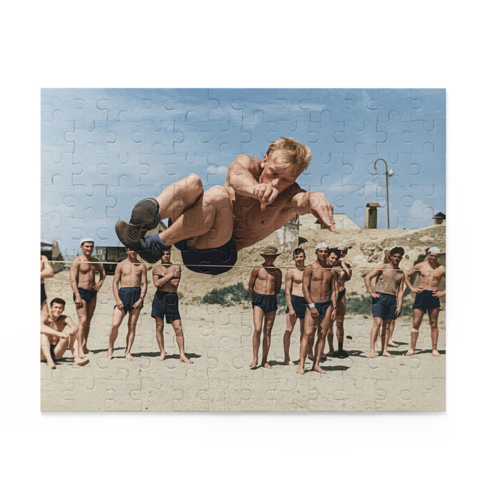 Historical jigsaw puzzle featuring a young athlete jumping above a rope at a beach competition