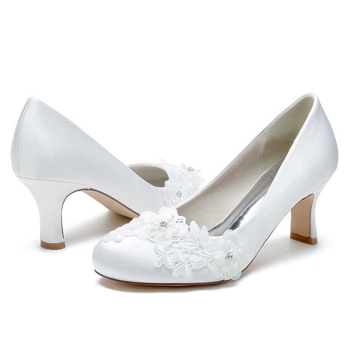 Elegant S&DCo. wedding shoes for bride low heel with floral embellishments in white satin