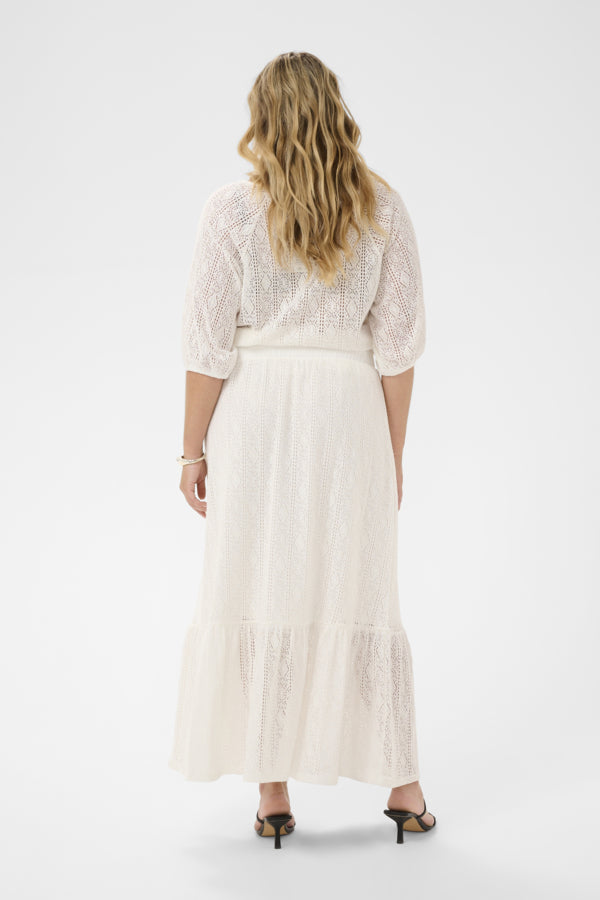 Woman wearing a white lace dress on a white background