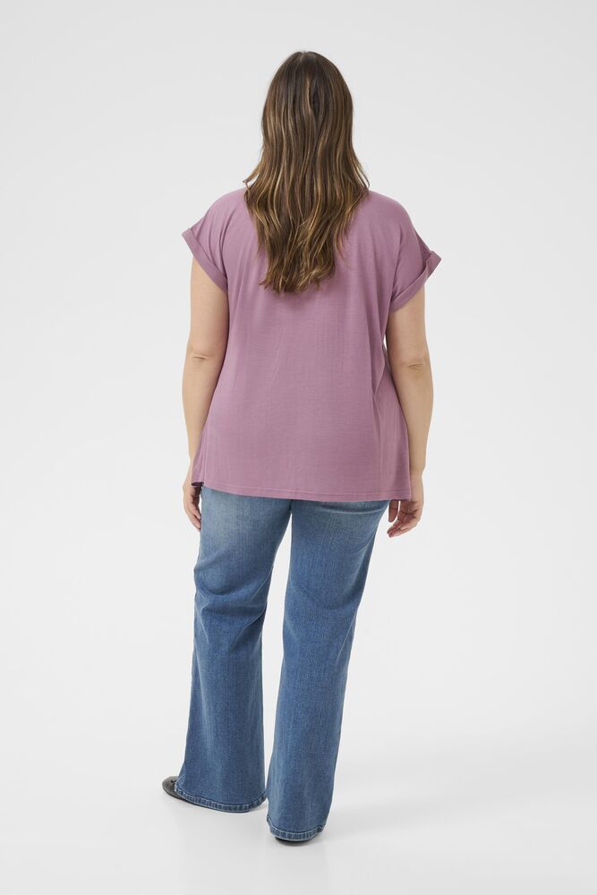 Person wearing a purple top and blue jeans on a white background