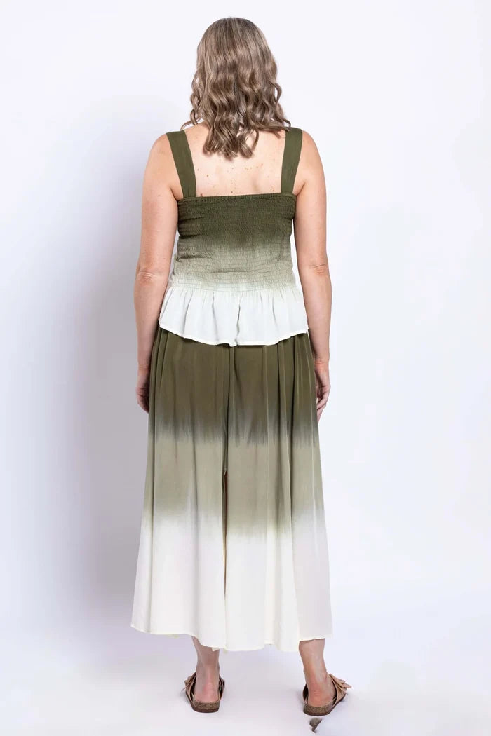 Woman wearing a green and white ombre dress on a white background