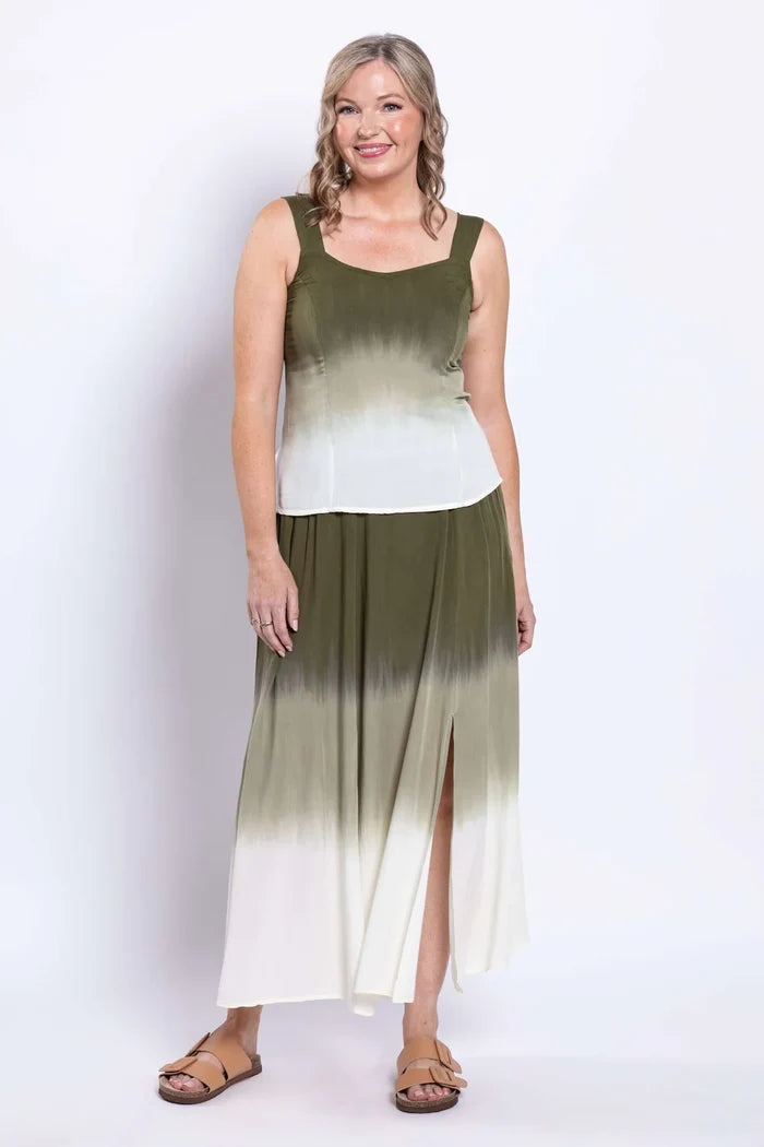 Woman wearing a sleeveless dress with a gradient design on a white background